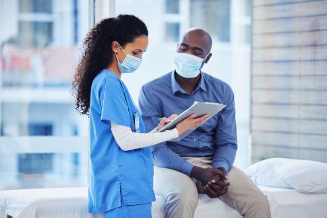 Doctor consultation, mask and patient results of a nurse with a black man in a hospital. 诊所, covid conversation and nursing communication with medical data and healthcare discussion for advice.